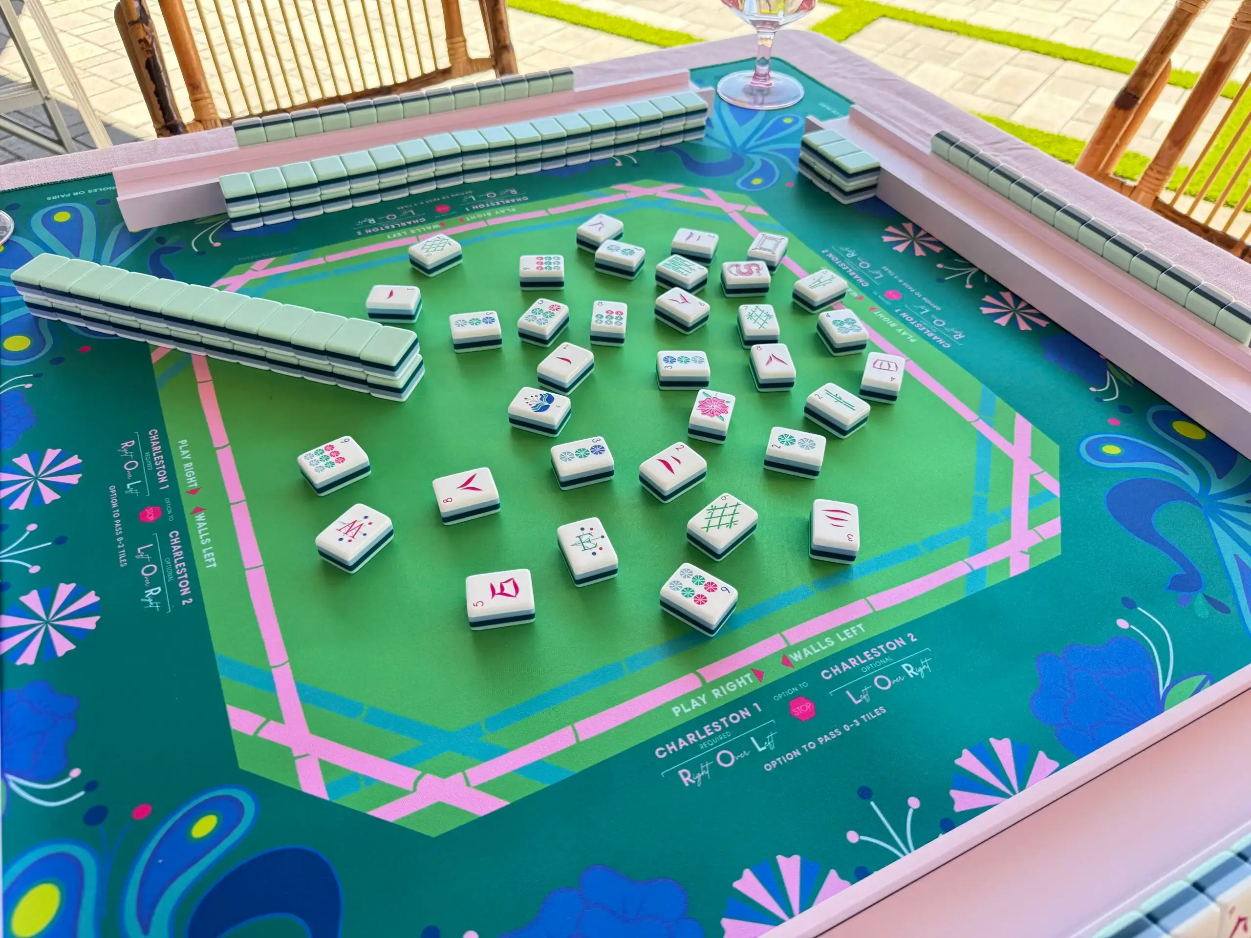 Mahjong tiles scattered on green playing table